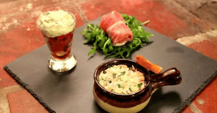 Chef garnishing a French starter in a restaurant kitchen