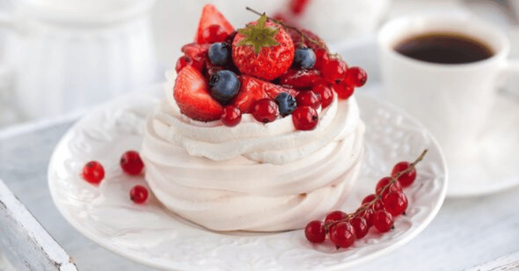 Meringue base cooling on a sheet of baking parchment