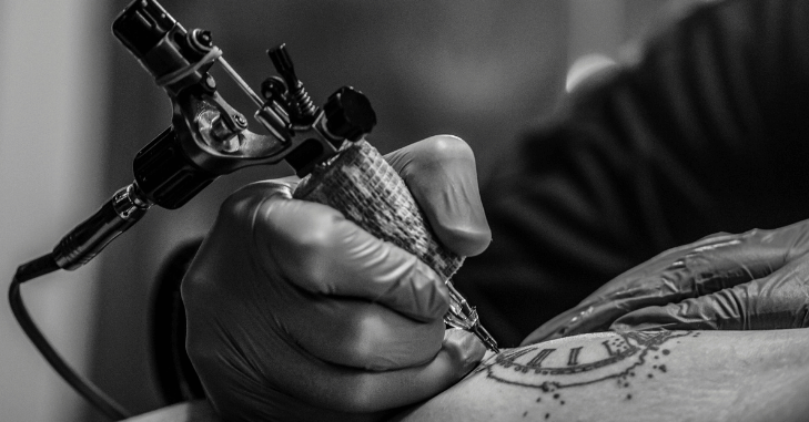 Artist discussing a custom design with a seated client