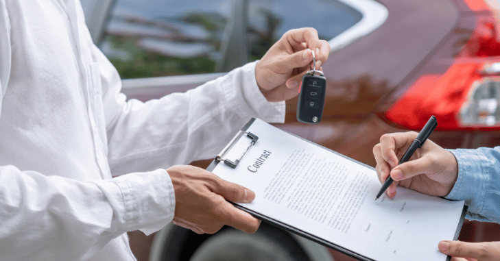 Dealer inspecting bodywork during a trade-in appraisal