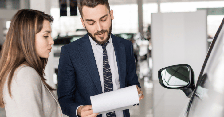 Buyer and dealer negotiating a part exchange deal at a desk