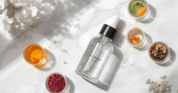Serum being massaged into the scalp along a parting